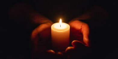 Hands holding candle thumb