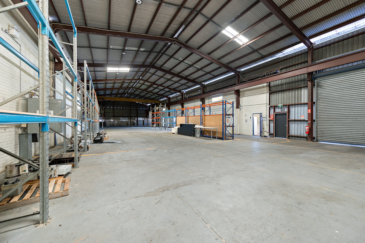 Industrial warehouse with crane and hardstand