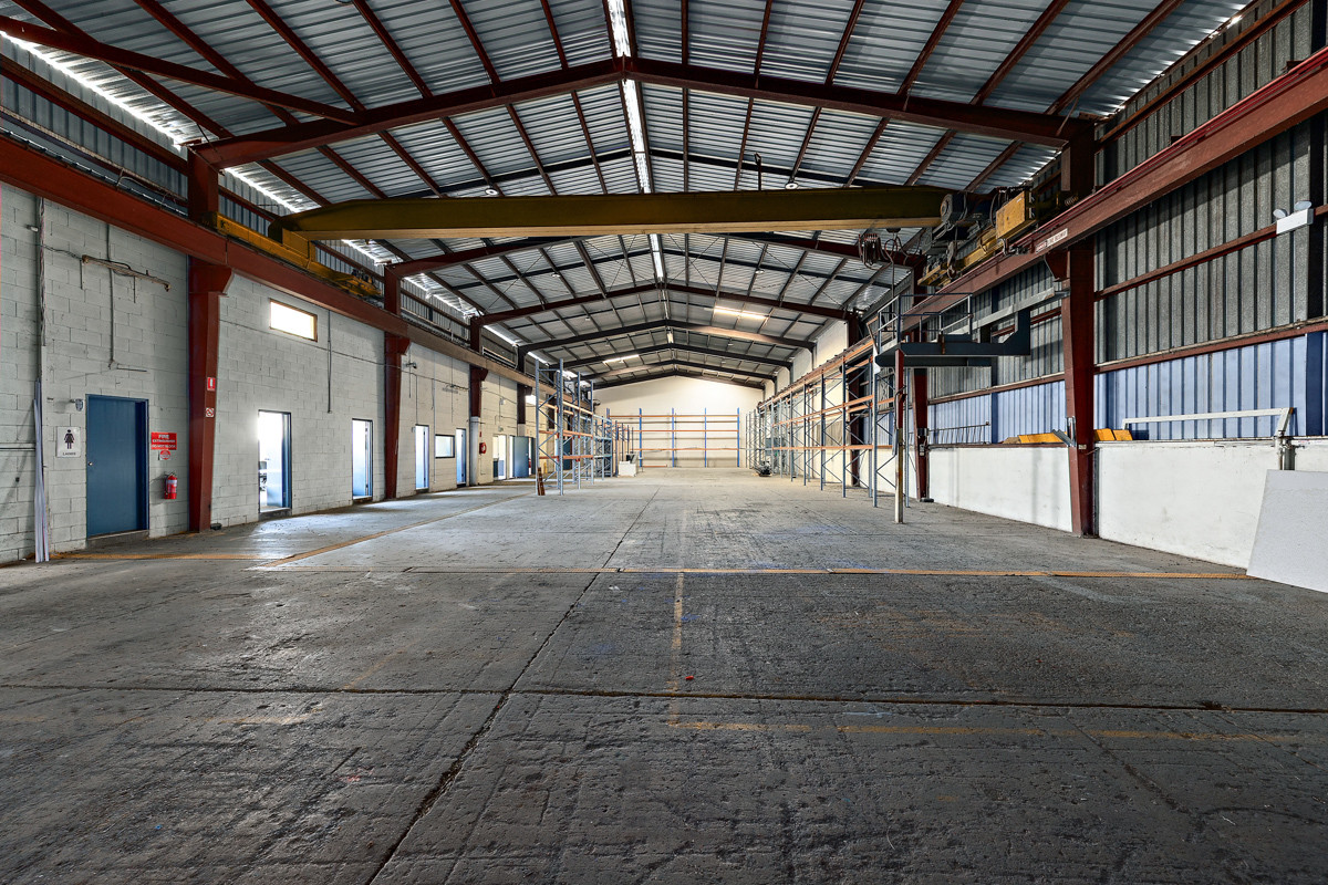 Industrial warehouse with crane and hardstand