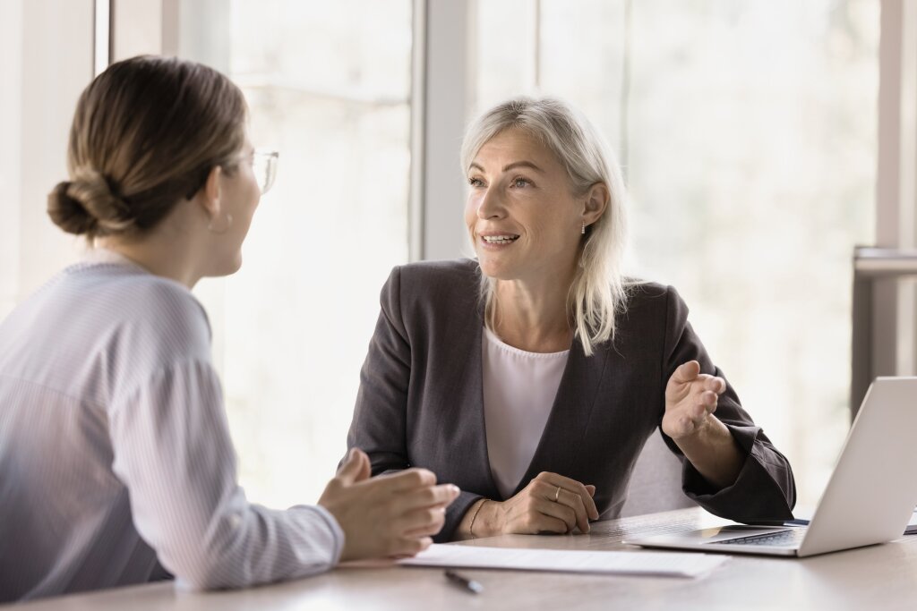 An experienced human resources manager provides guidance and feedback to an employee or student during a performance review or workplace consultation.