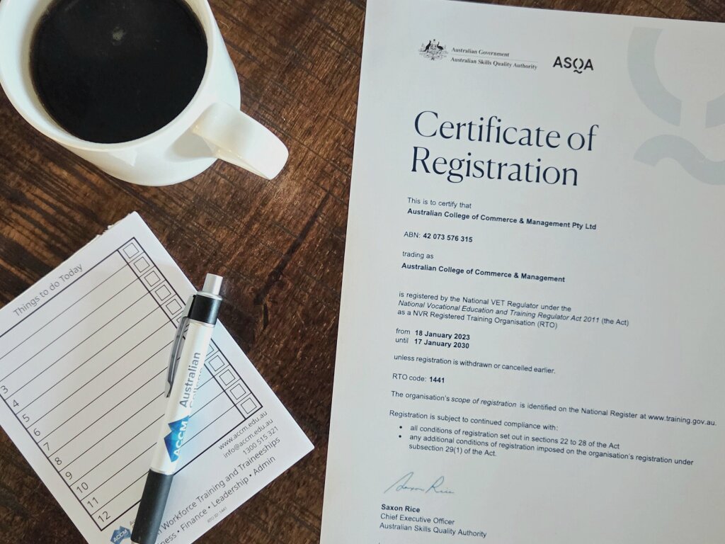 The official ASQA Certificate of Registration for the 51���� of Commerce and Management on a desk, confirming RTO compliance.