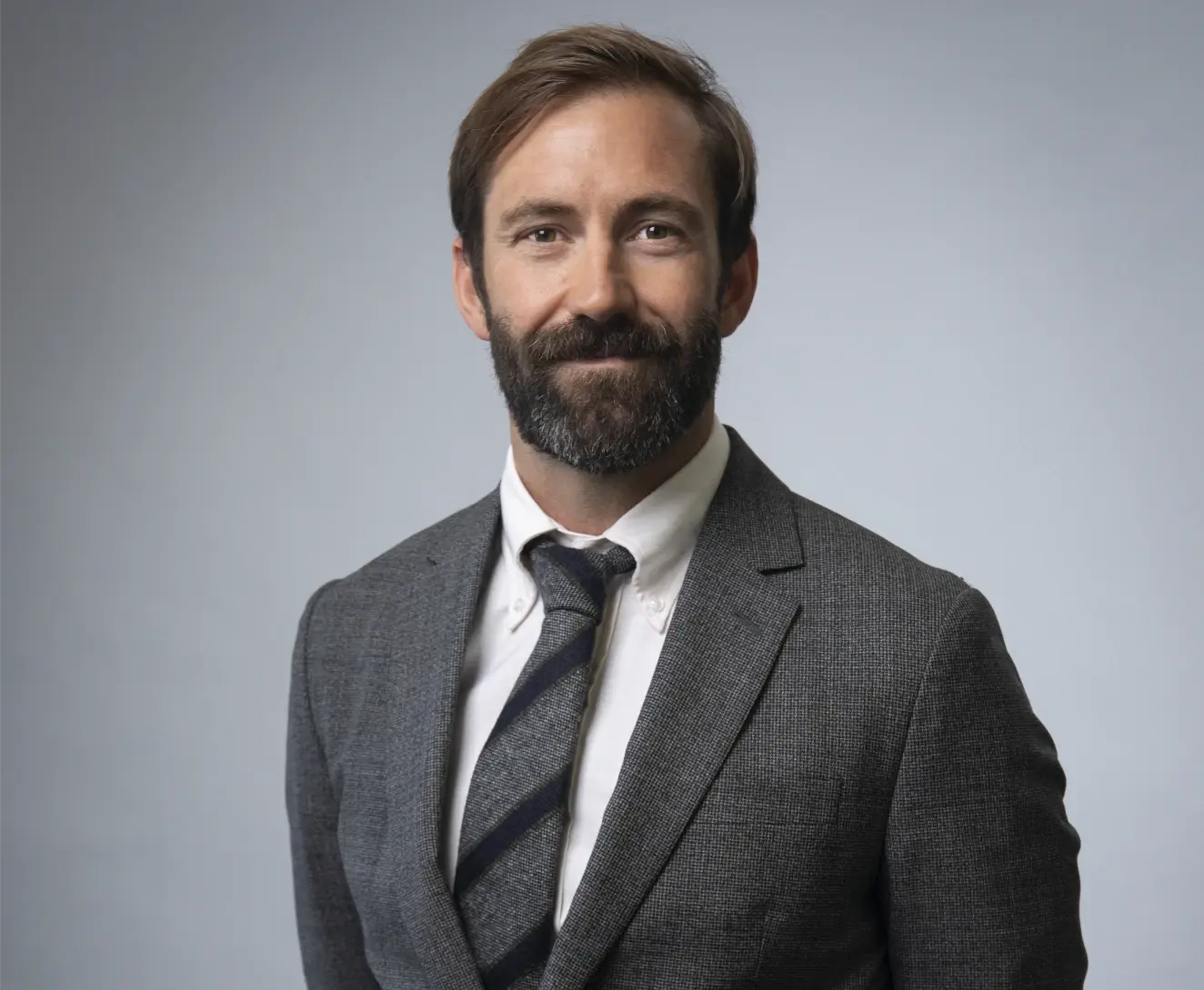 Chris Easton, professionally dressed, smiling warmly. Conveys approachable and confident through attire and expression