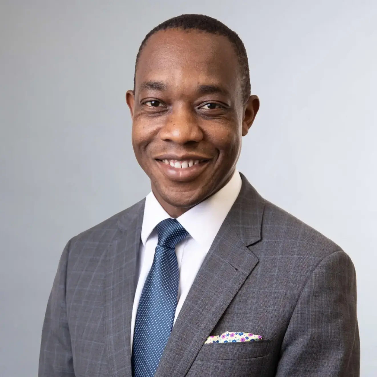 Dr. Tapuwa Musuka smiling in professional attire.
