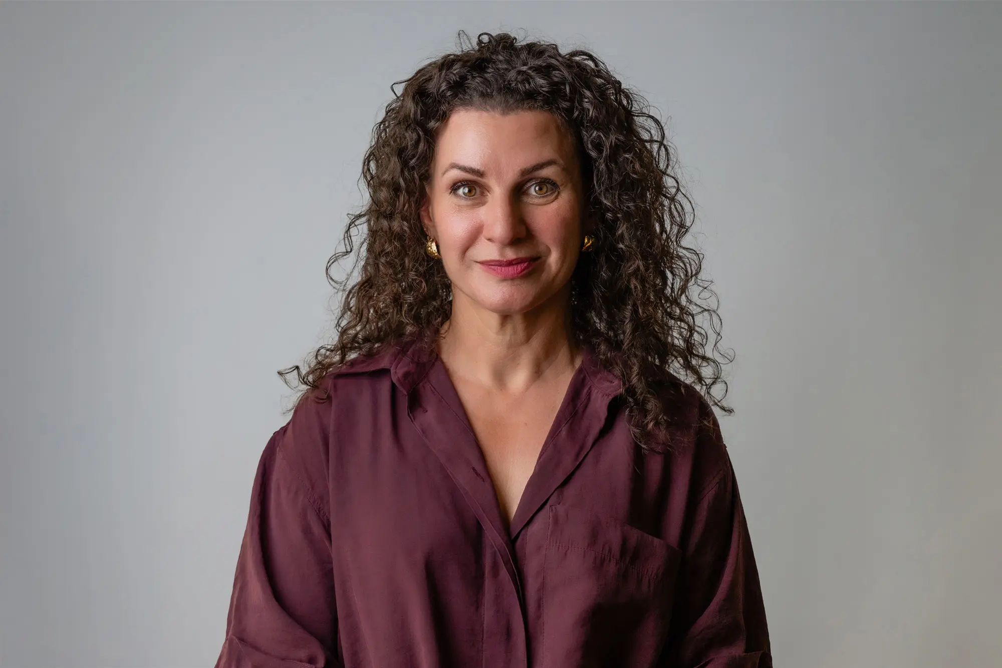 Sheree O'Sullivan, professionally dressed, smiling warmly. Conveys approachable and confident through attire and expression