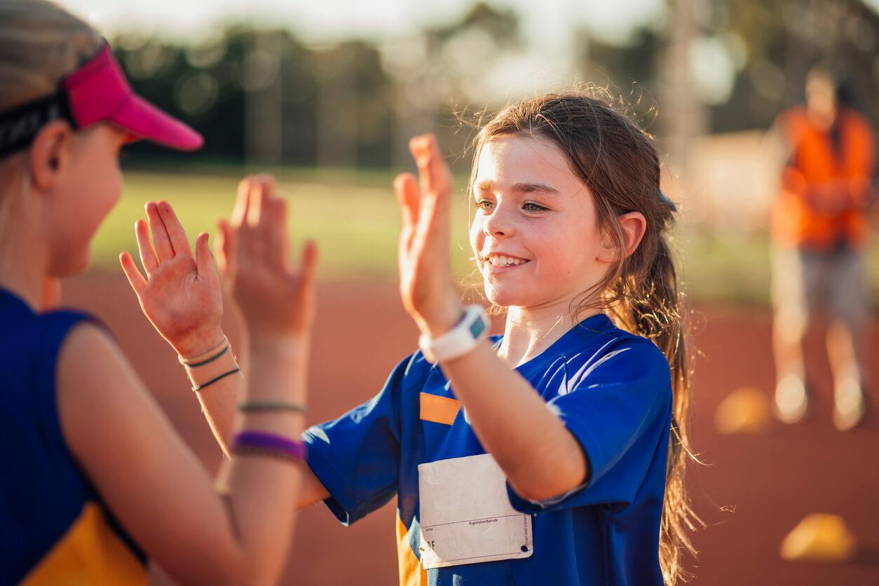 Young girls in sports team celebrating a win