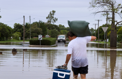 IMG - Responding to a Natural Disaster - Tip Sheet man saving his belongs in the middle of a flood