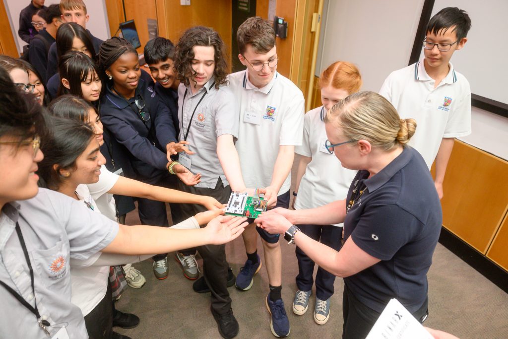 The BinarX Students hand over their Camera Payload to BinarX Program Co-Ordinator Meg Berry at Curtin University.