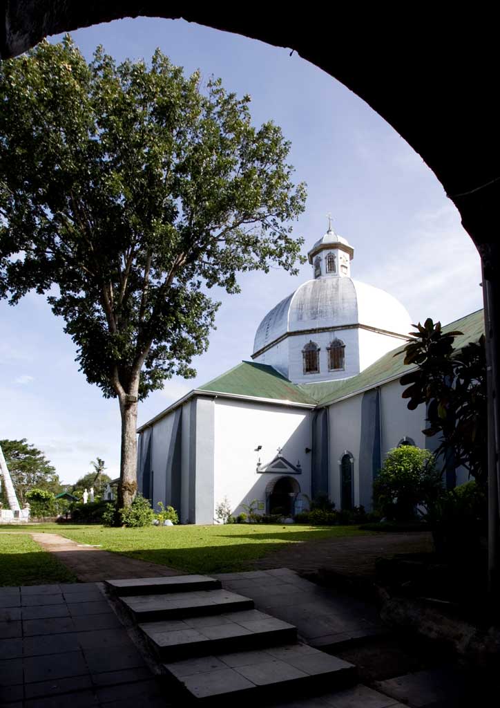 The exterior of a Batangas church with a great white dome.