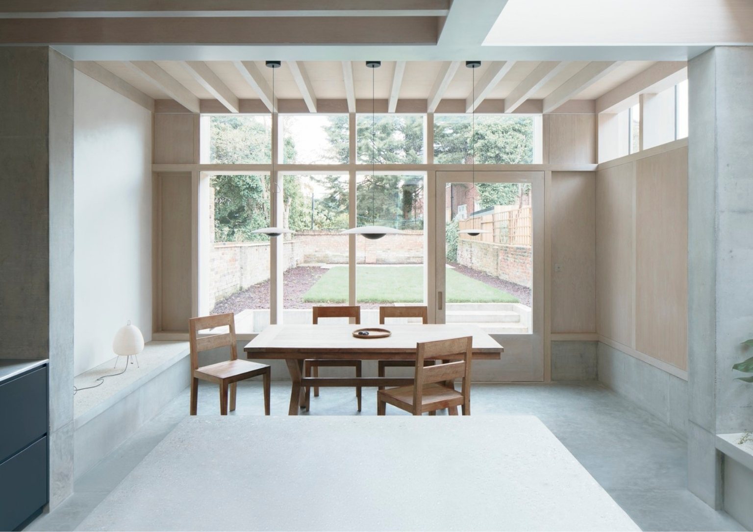 view from the kitchen island overlooking a small dining area with a view of the backyard