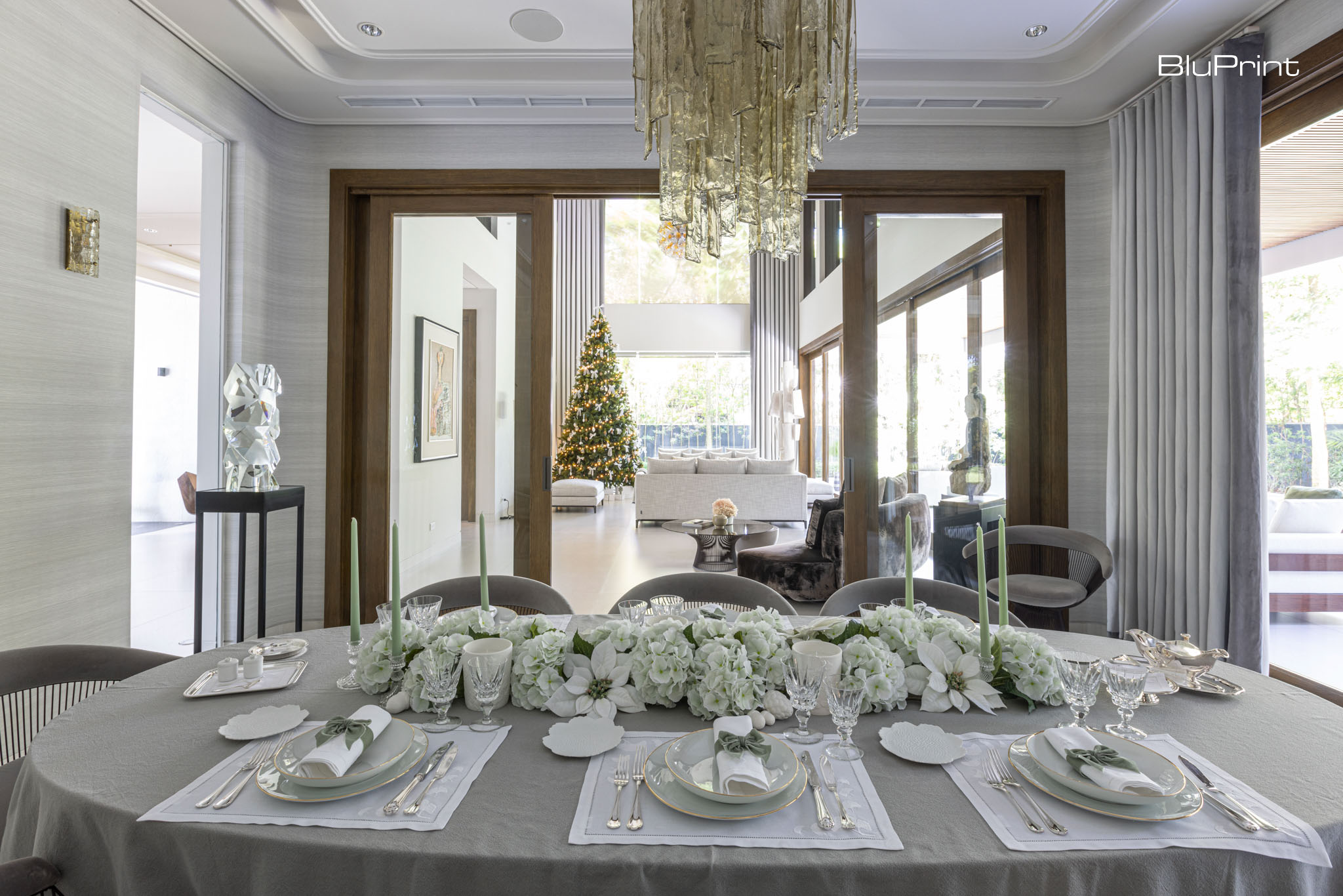 Dining table set with fancy dinnerware and floral centerpieces