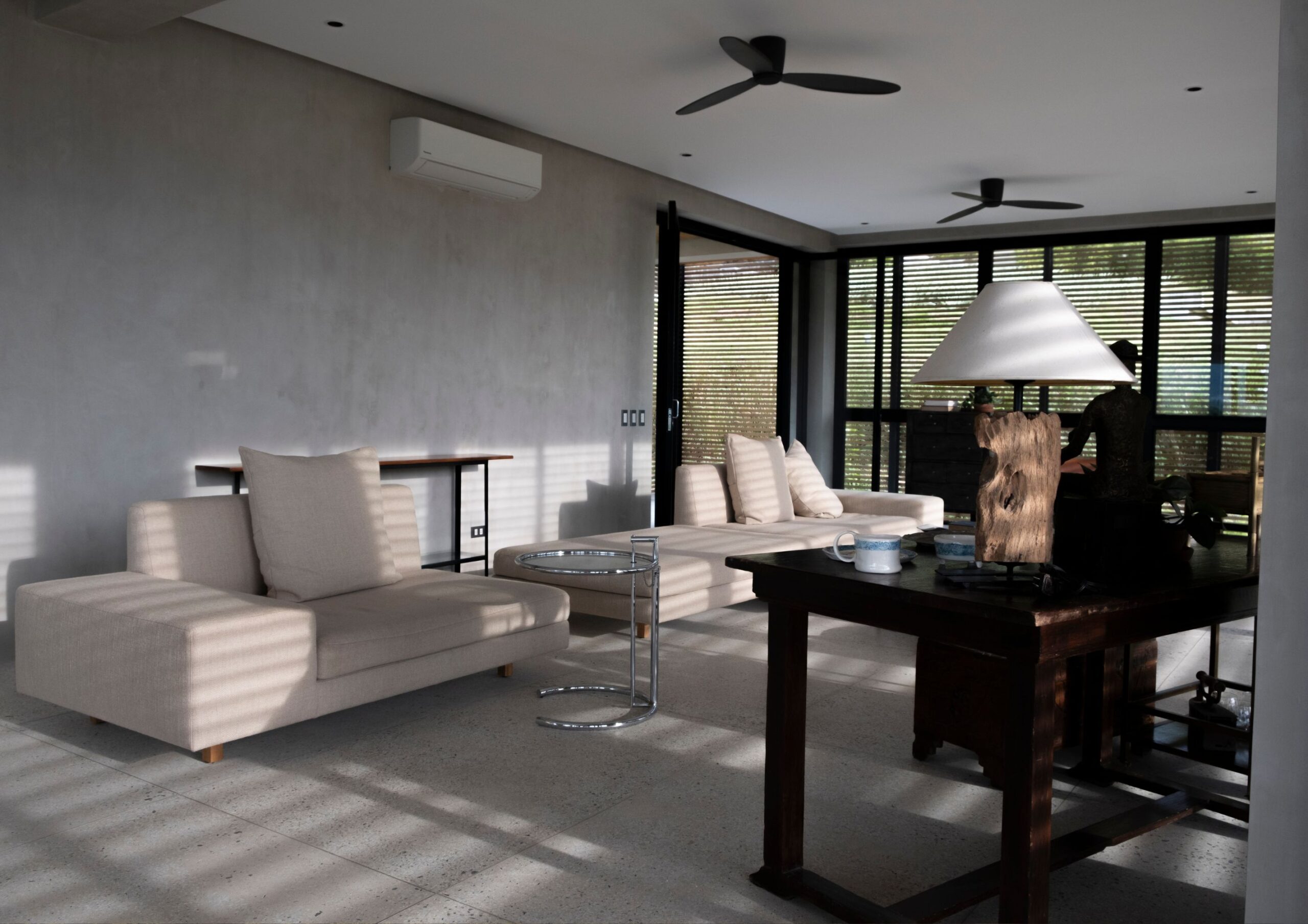 shadows cast on modern sectionals in a living room.