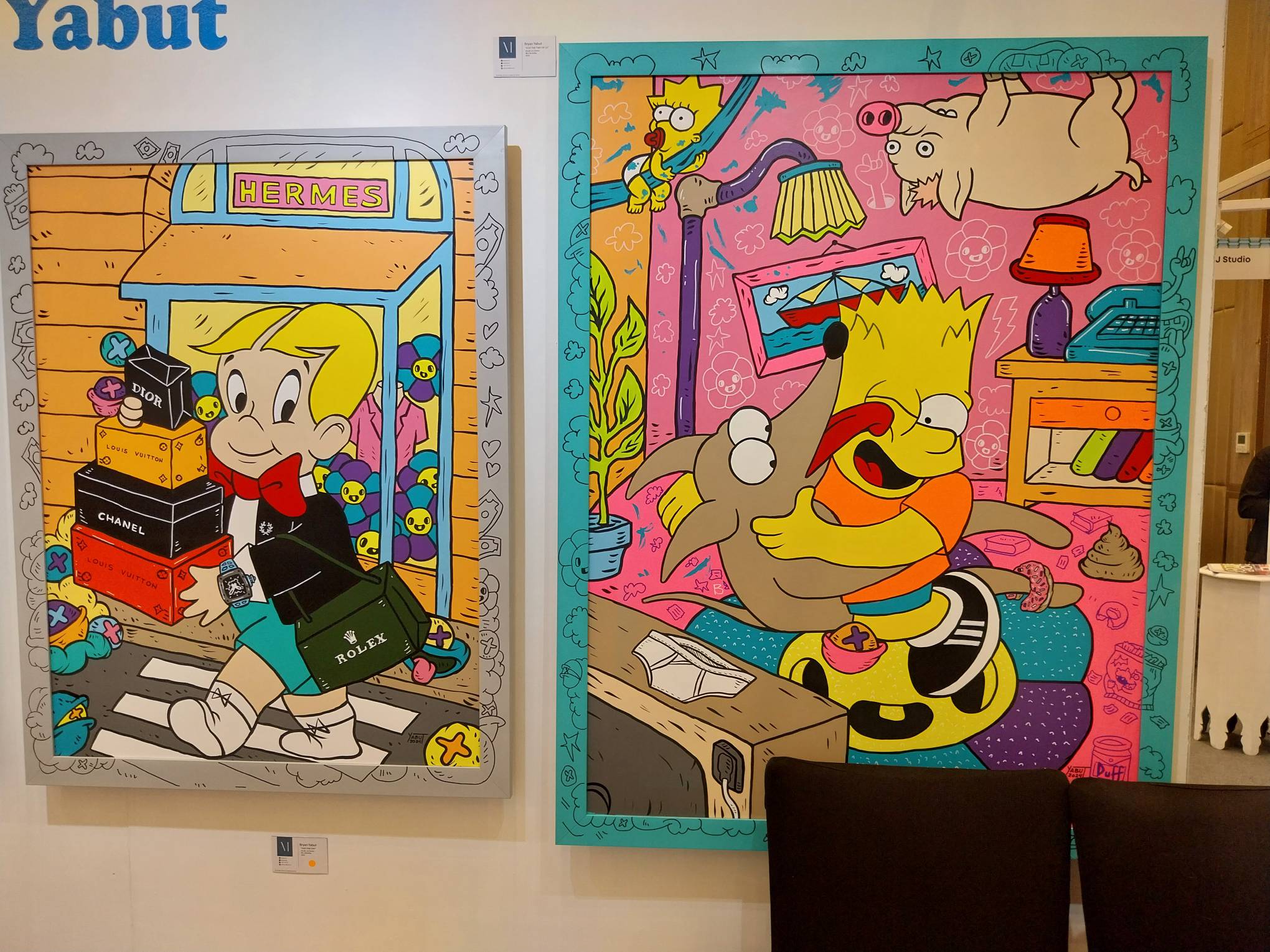 Two paintings of Richie Rich and of the Simpsons. Photo by Elle Yap.