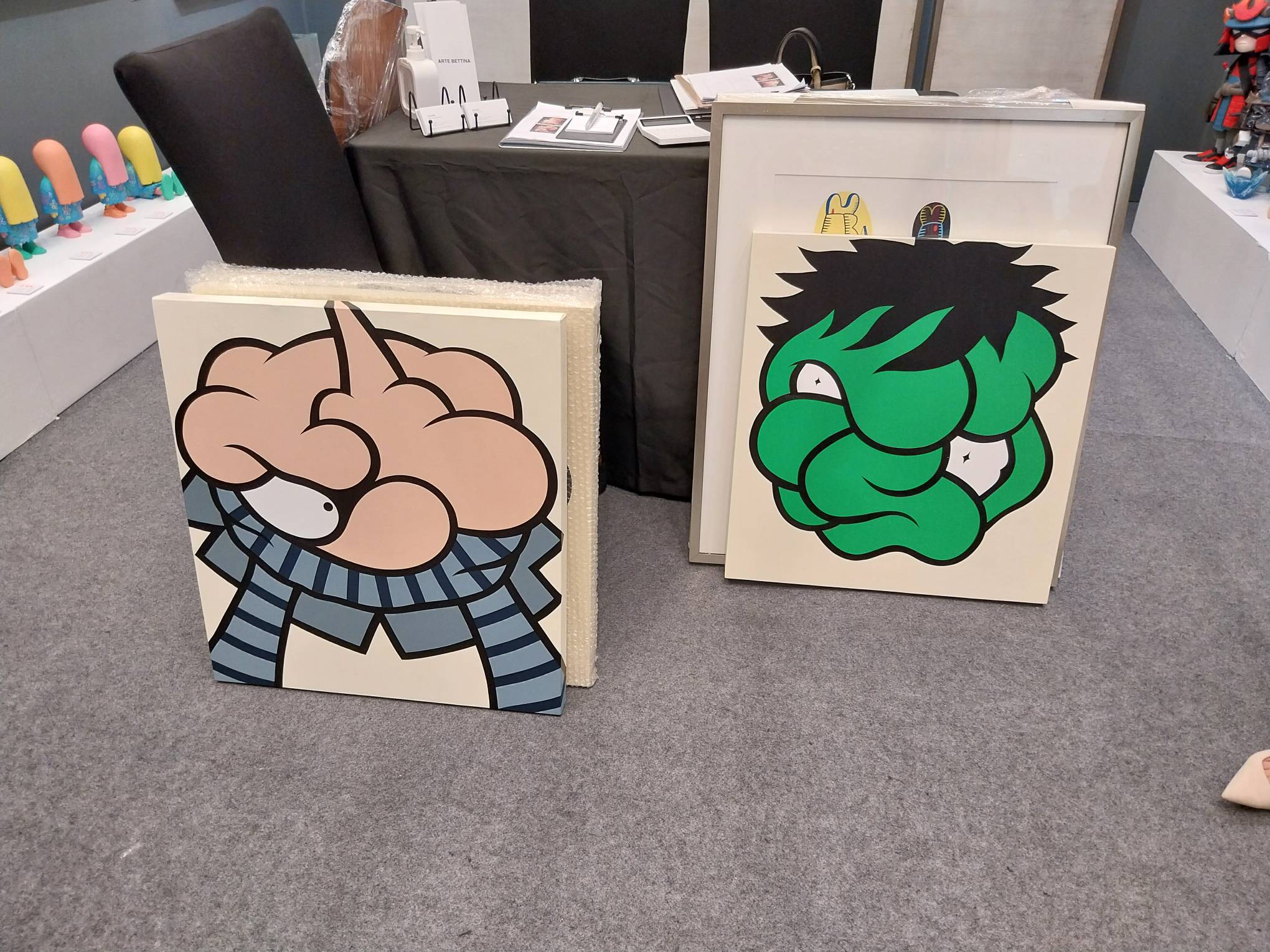 Paintings which reference Gru from "Despicable Me" and the Hulk. Photo by Elle Yap.