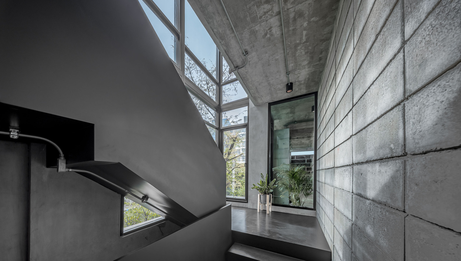 Narrow stairwell with mirrors and windows. Photo by Witsawarut Kekinna.