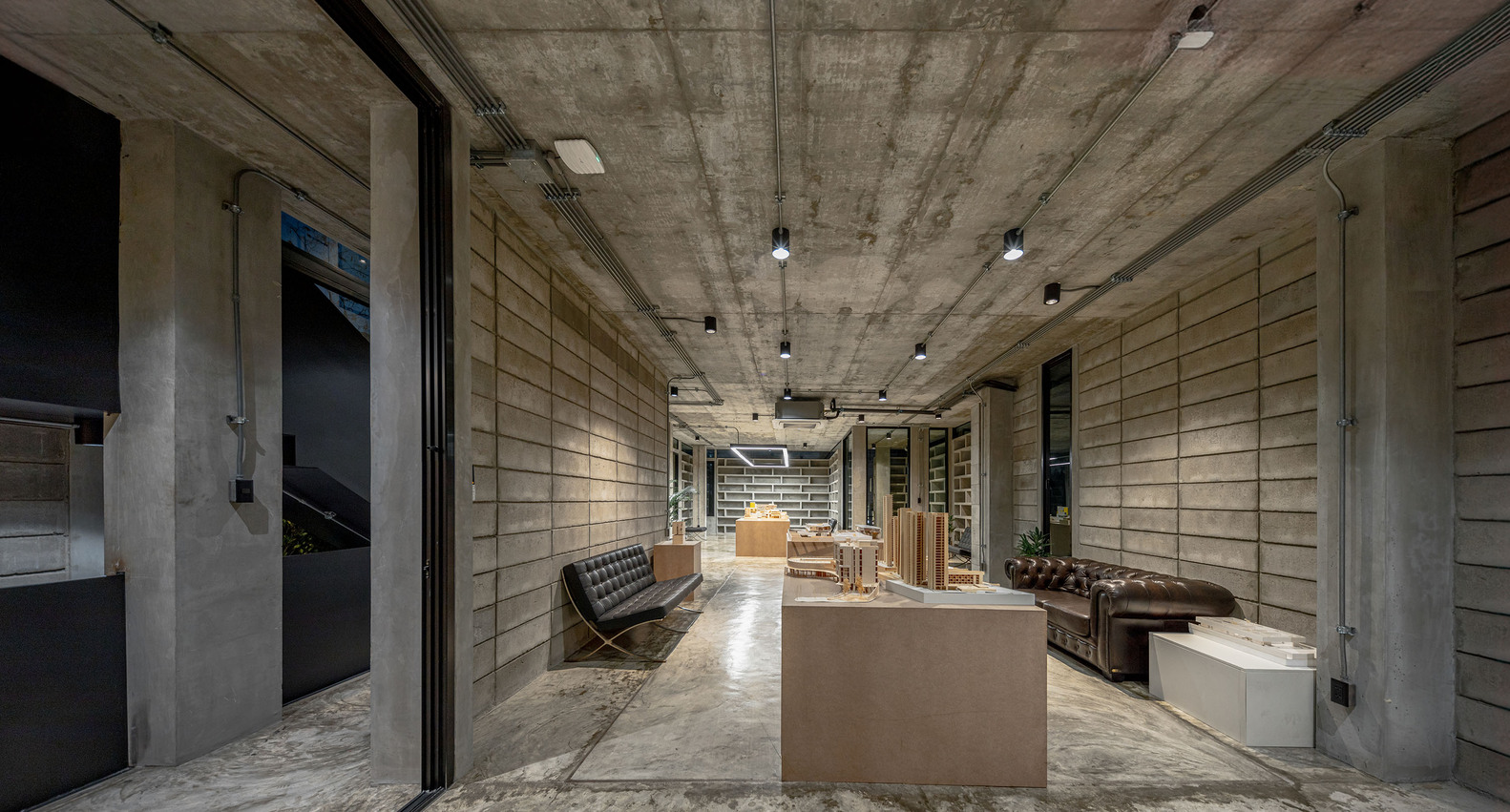 An office space area with couches and a table. Photo by Witsawarut Kekinna.