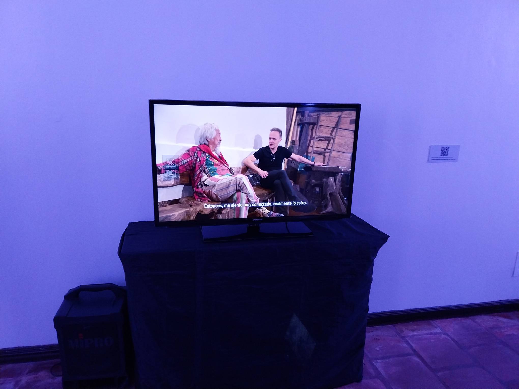 A television playing "Cosmic Encounters" by Enrique Marty.