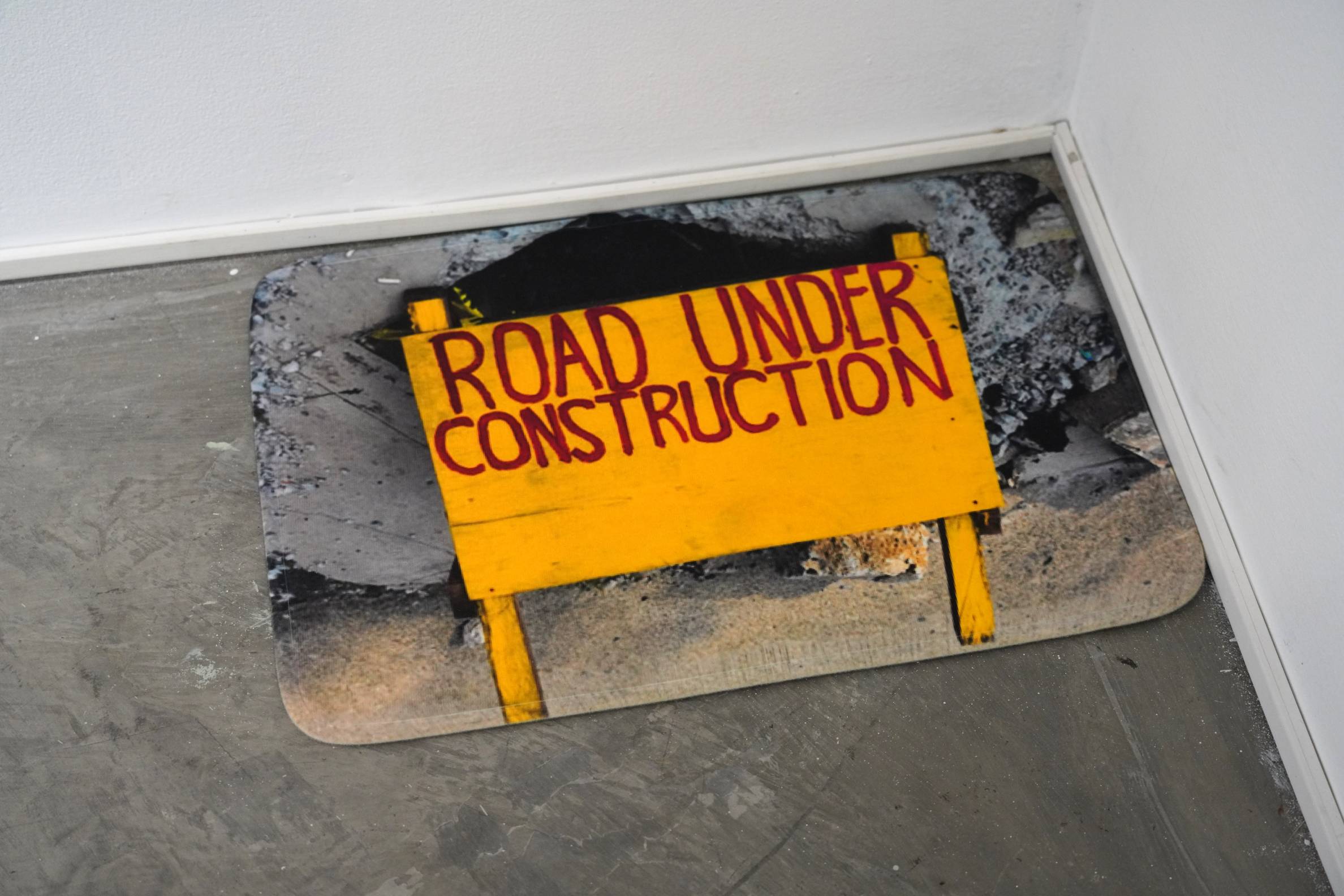 Road under construction sign shown at "either/or." Photo provided by artist.