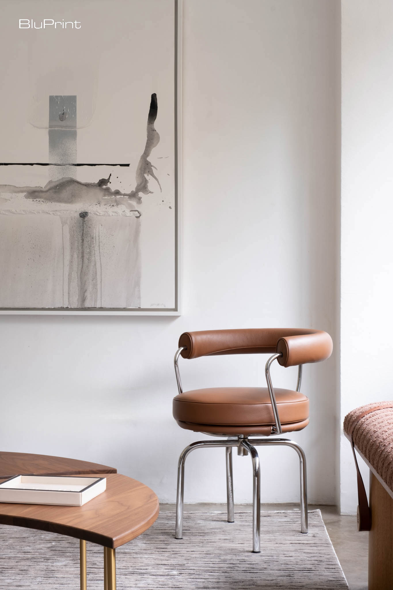 Detailed shot of a chair by a painting.