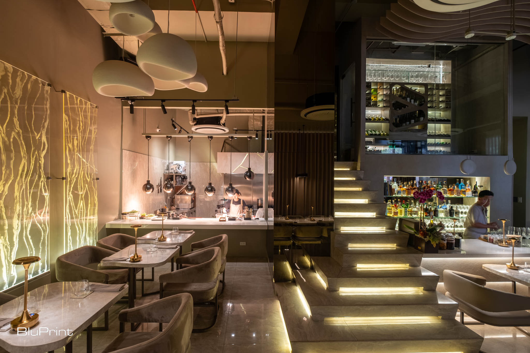 Portion of Taupe restaurant where the bar and the show kitchen are seen.