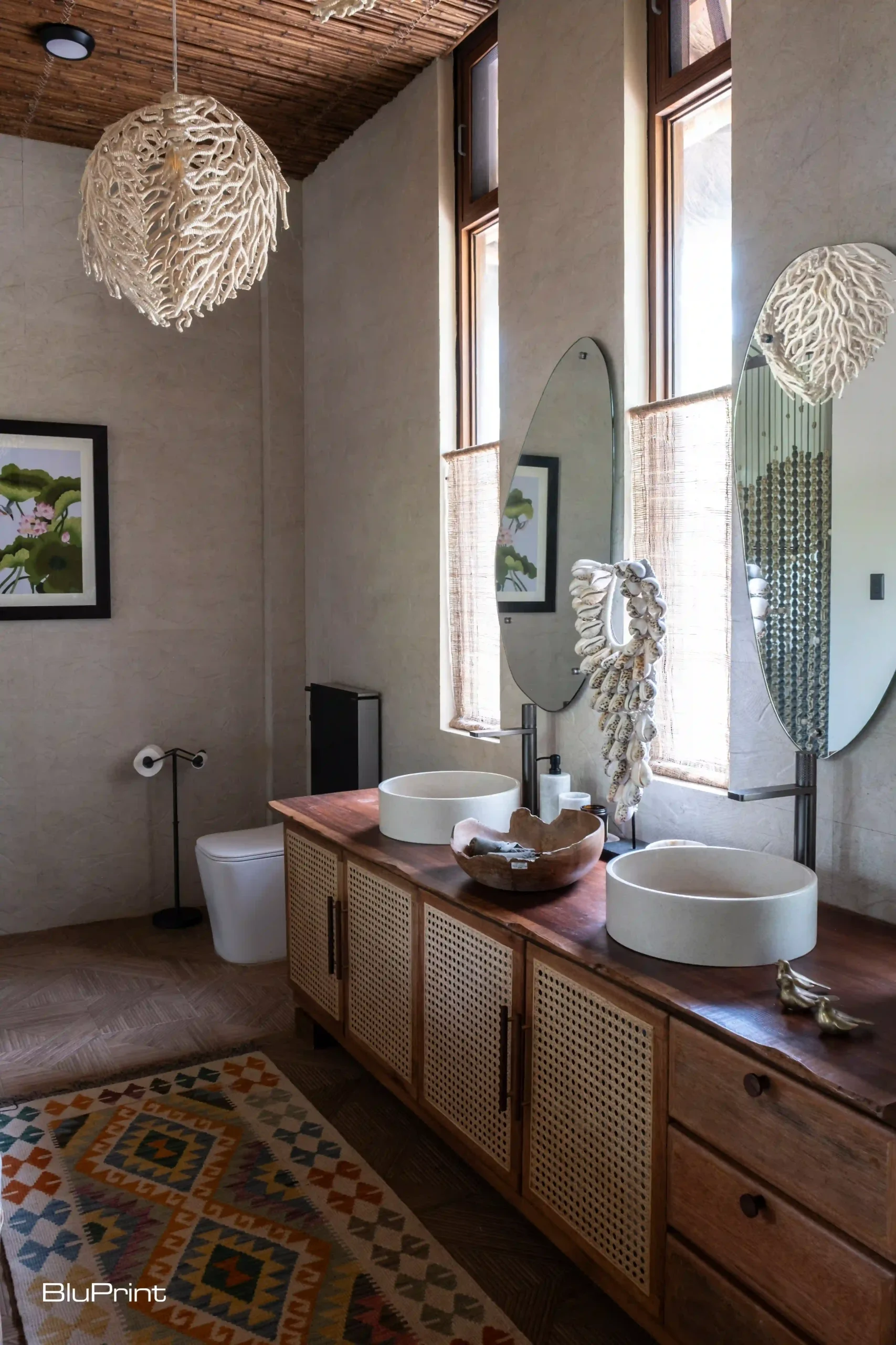 Toilet and bath at Aman Sinaya, with a coral lamp hanging from the ceiling.