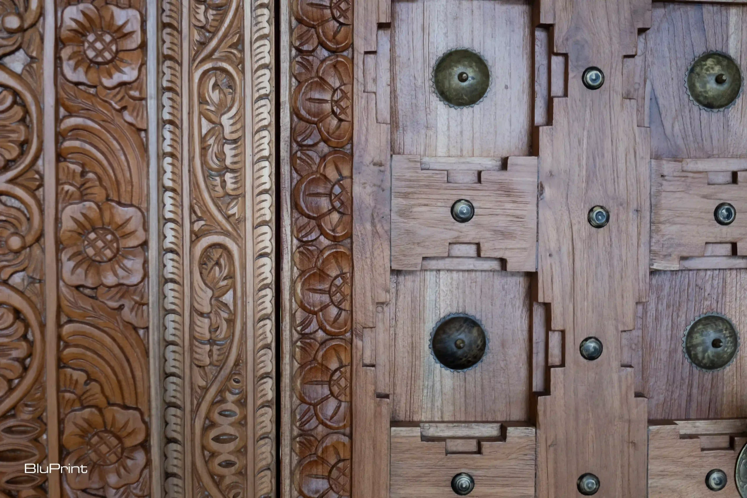 Closeup shot showing intricate carvings of a Balinese door.
