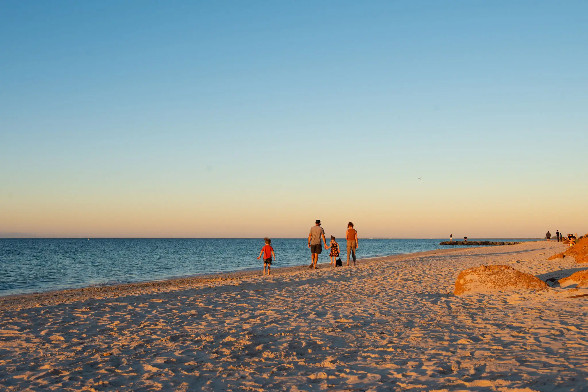 Happy family walking along a Busselton foreshore