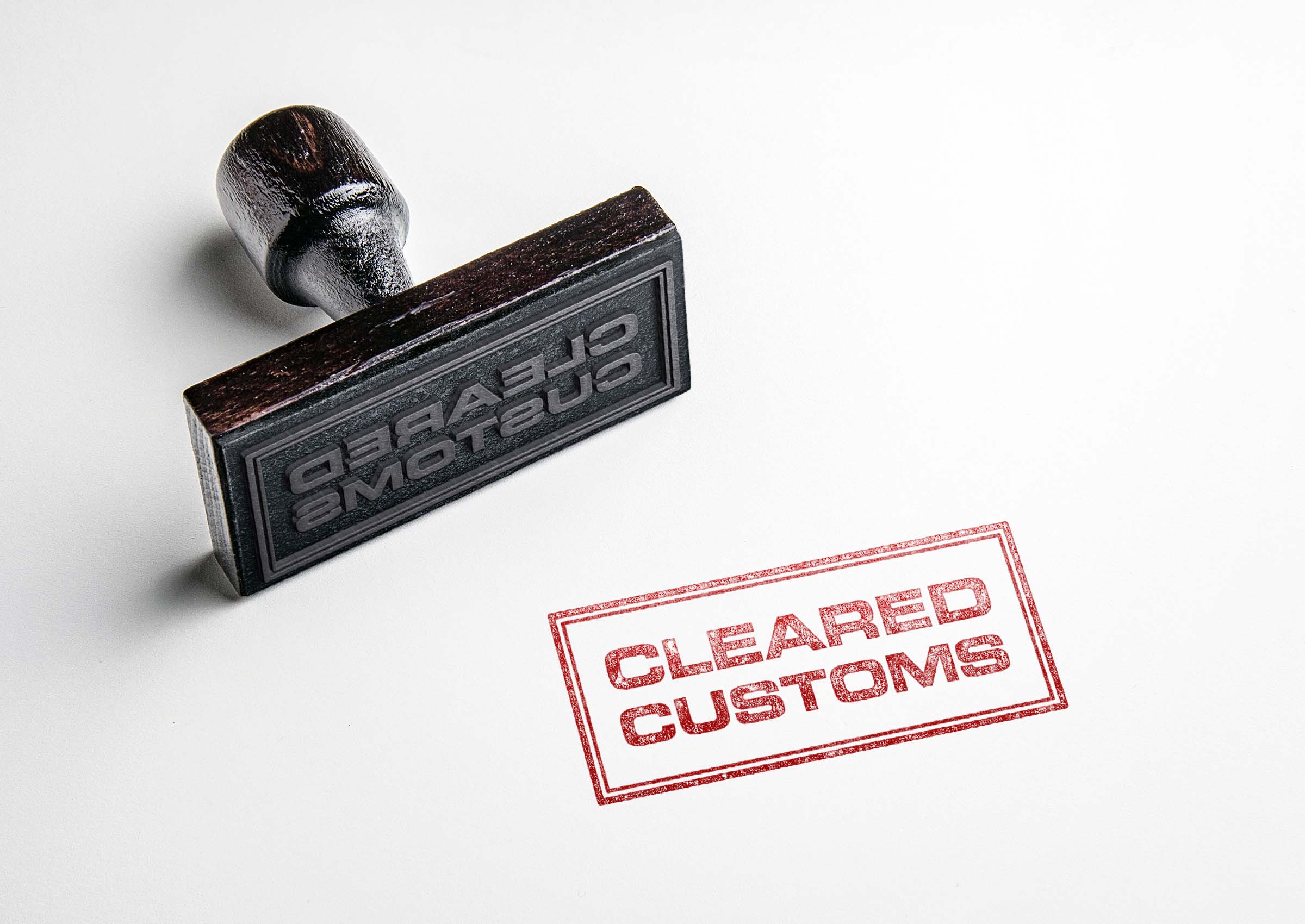 Rubber,Stamping,That,Says,'cleared,Customs'.