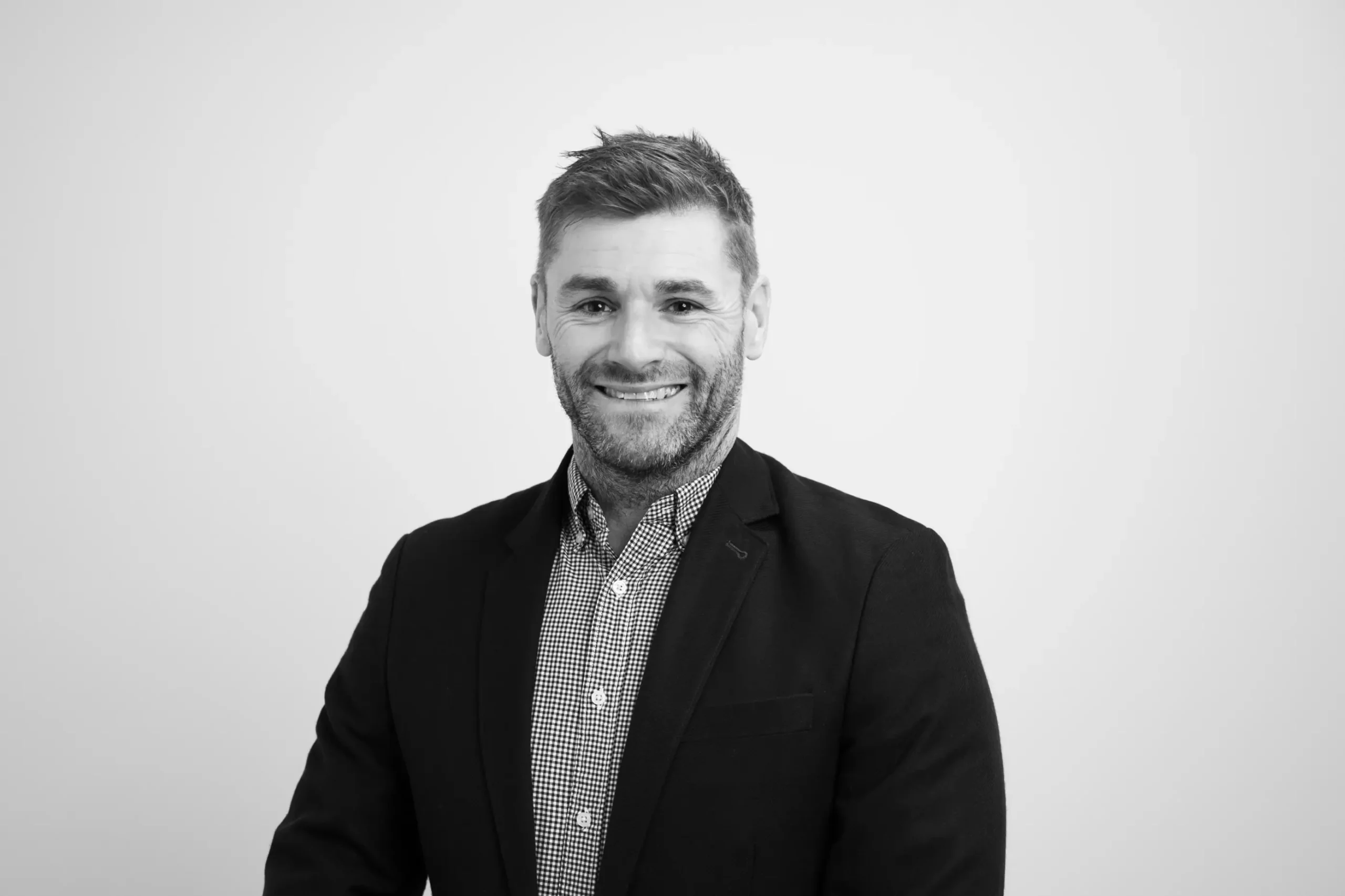 Andrew Mallon smiling in corporate attire