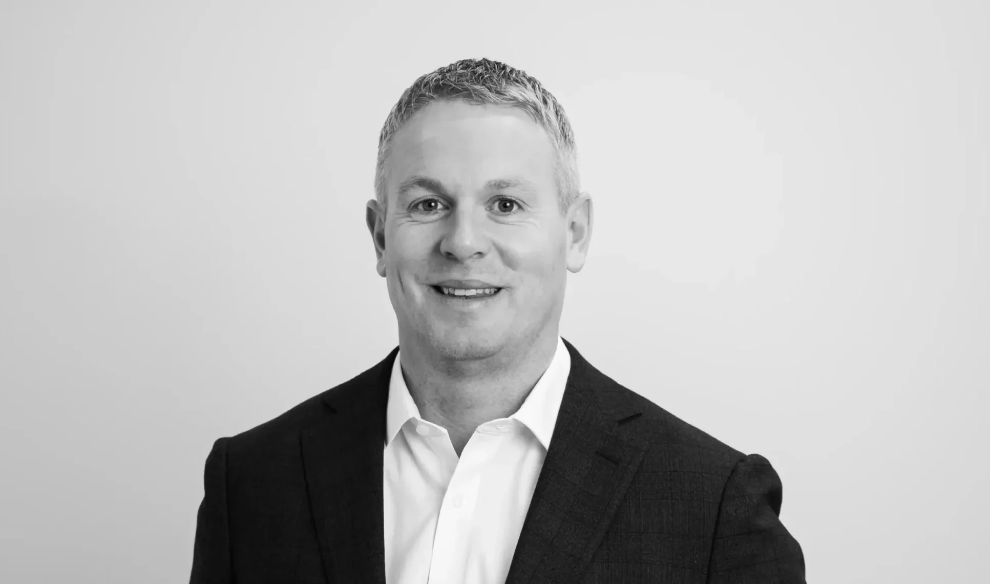 Eanna Doolin smiling in corporate attire