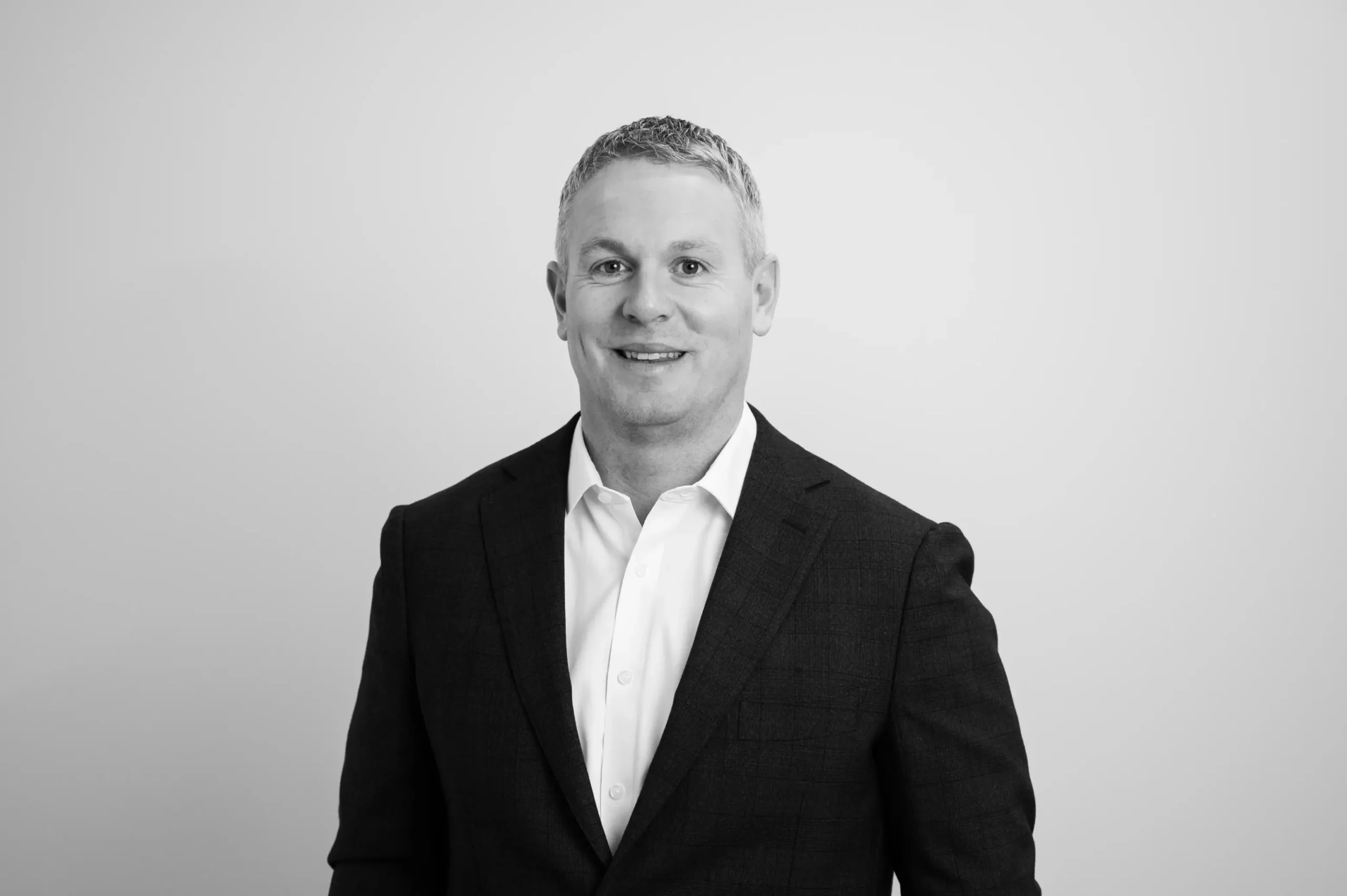 Eanna Doolin smiling in corporate attire