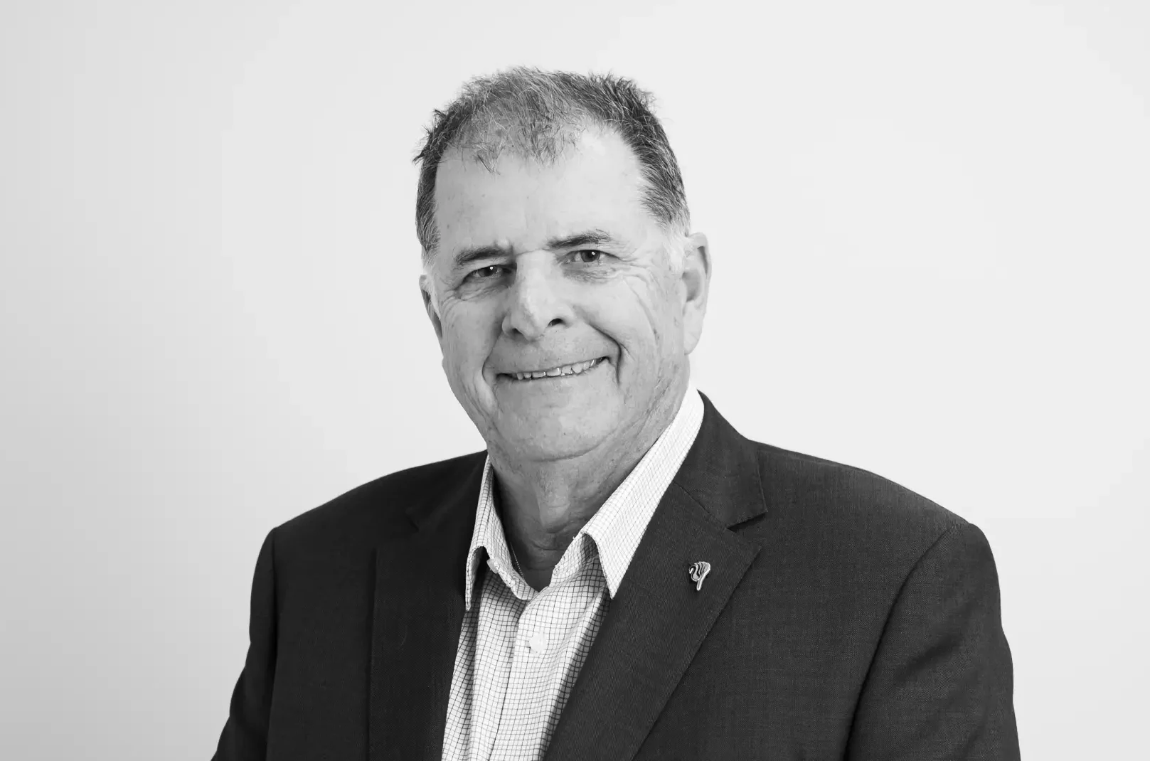 Graeme Harman smiling in corporate attire
