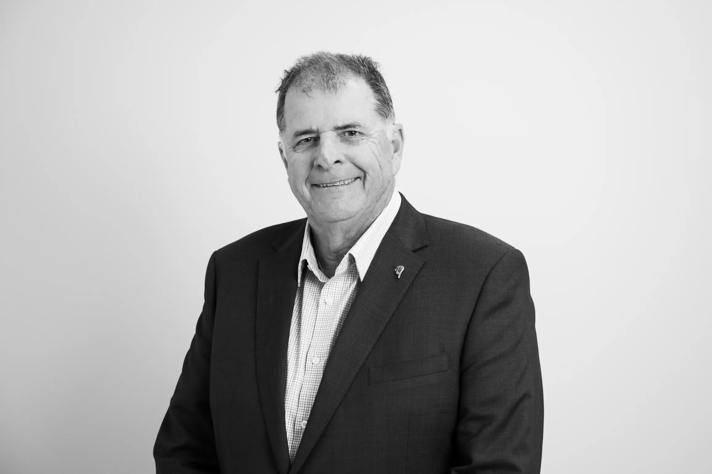 Graeme Harman smiling in corporate attire