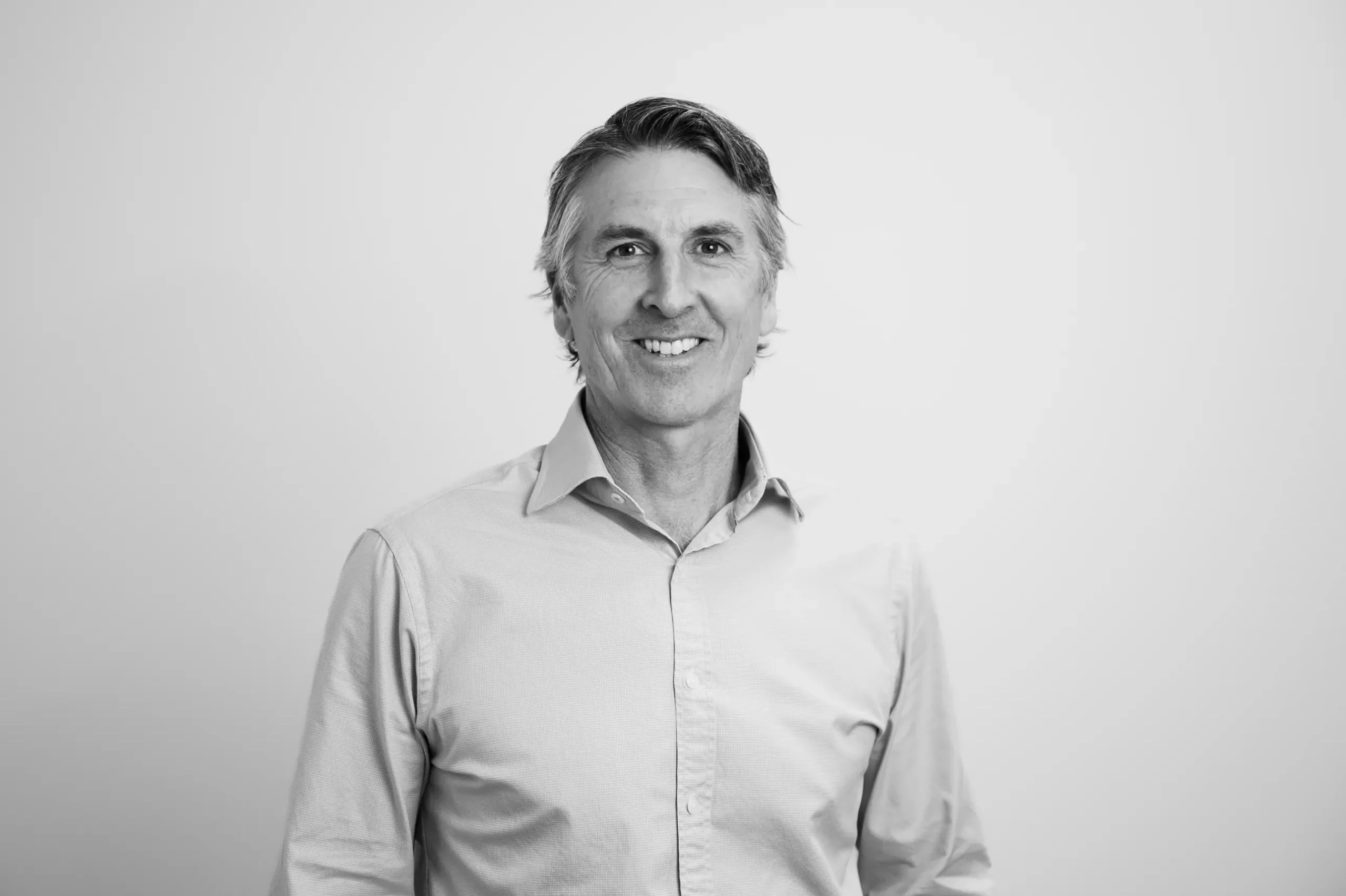 Jeremy Bower smiling in corporate attire