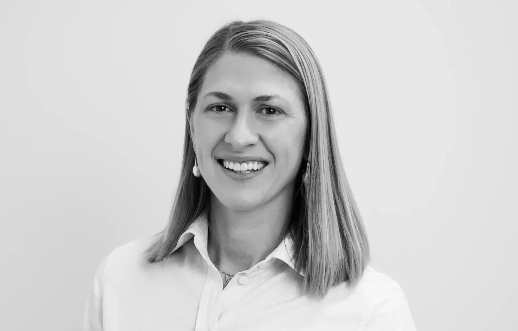 Jessica Kiekebosch-Fitt smiling in corporate attire