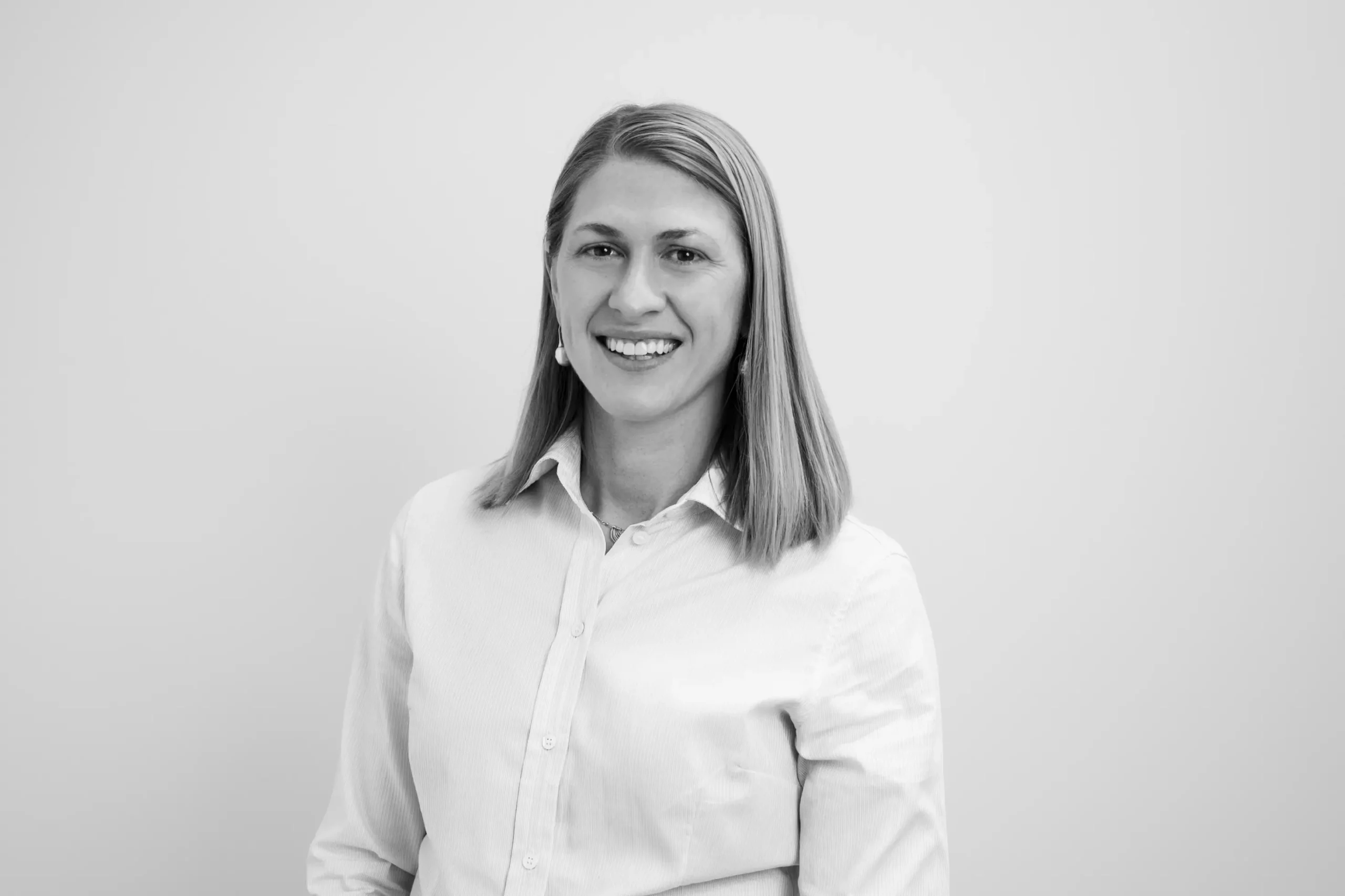 Jessica Kiekebosch-Fitt smiling in corporate attire