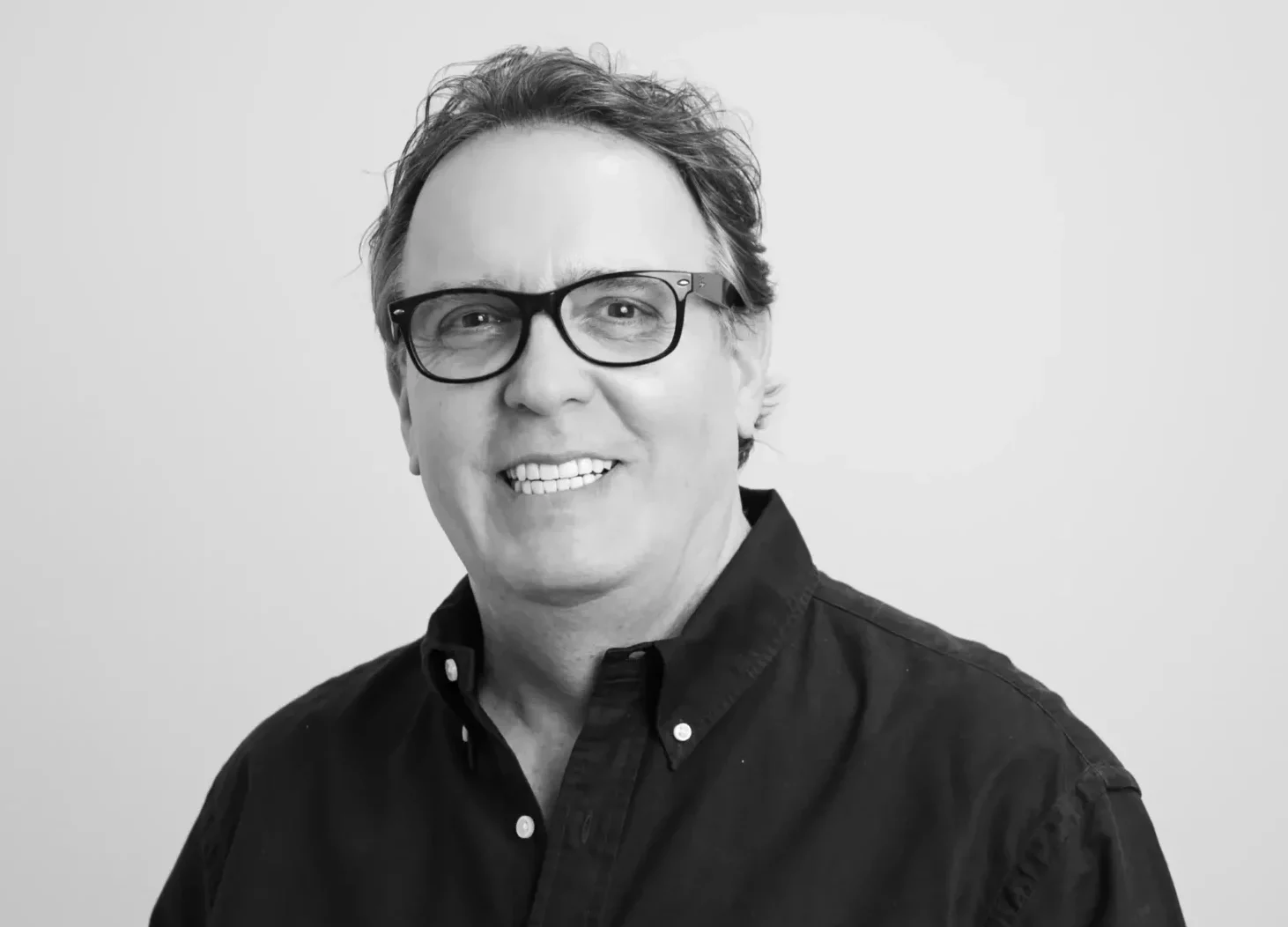 Tim Collins smiling in corporate attire