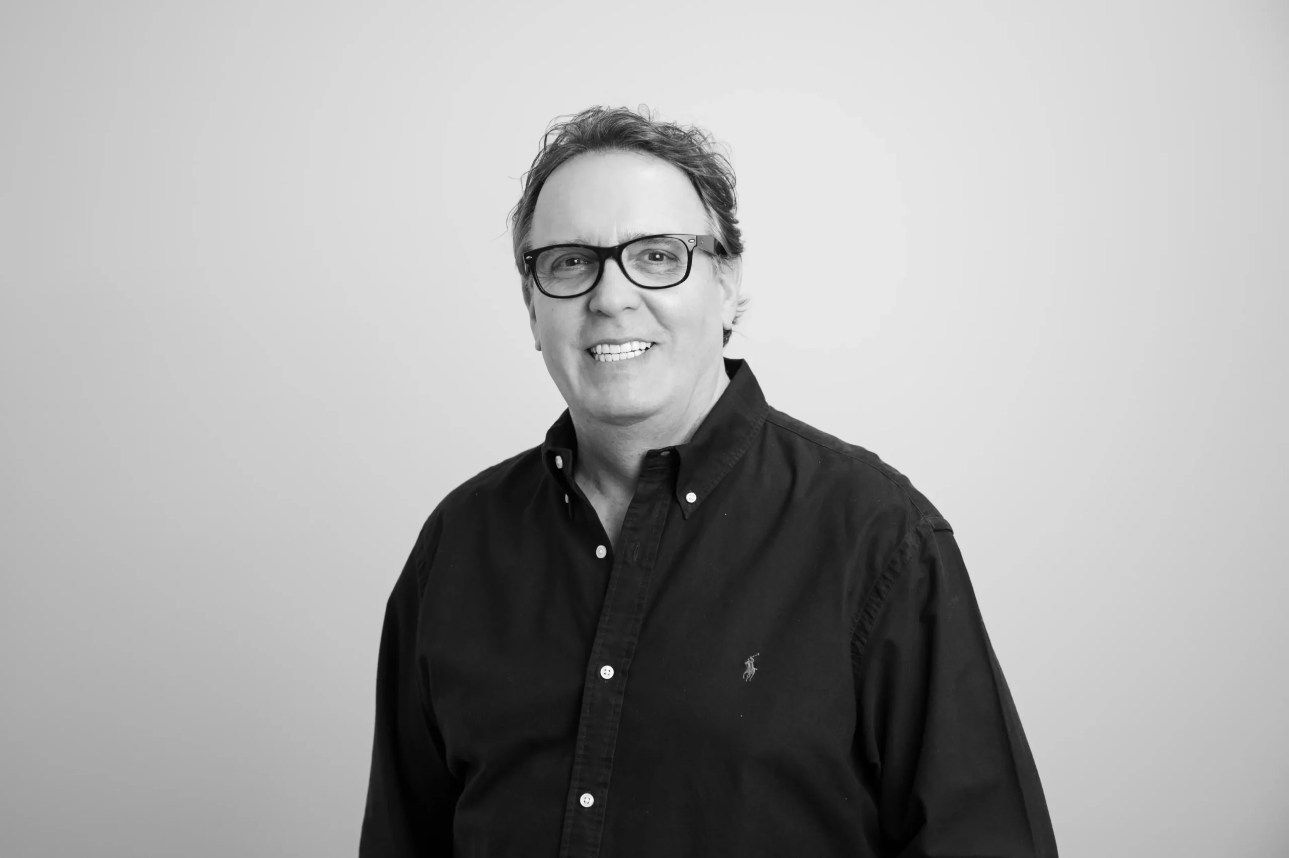 Tim Collins smiling in corporate attire