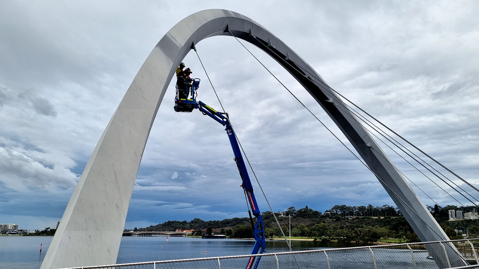 Engineering on EWP mounted on barge inspecting Elizabeth Quay Pedestrian Bridge.