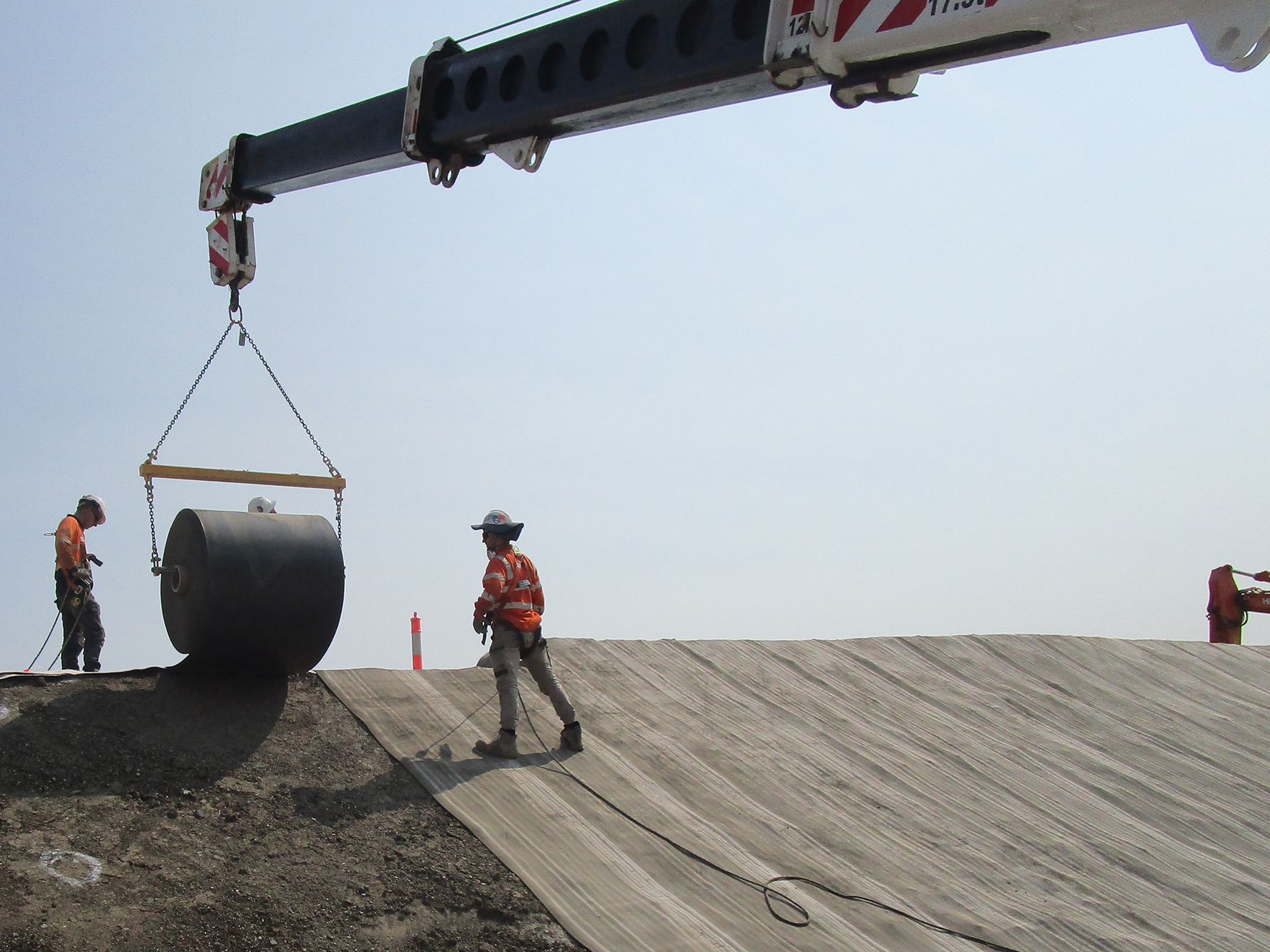Engineers installing Concrete Canvas roll on slope