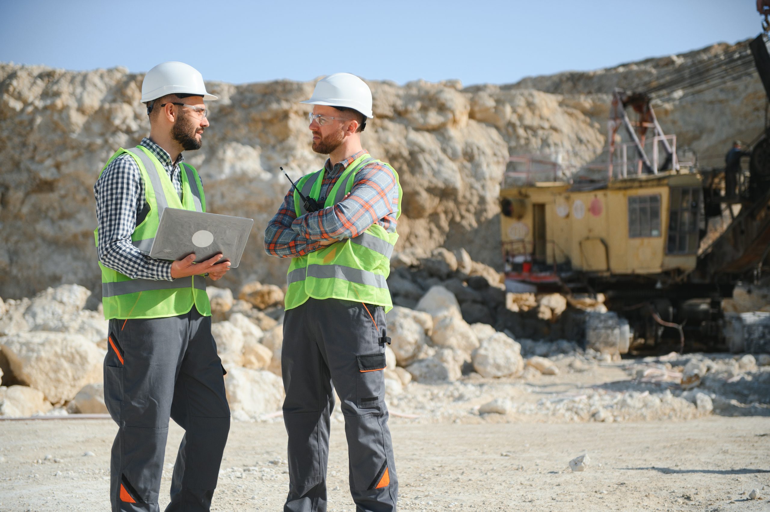 Workers talking in rock quarry