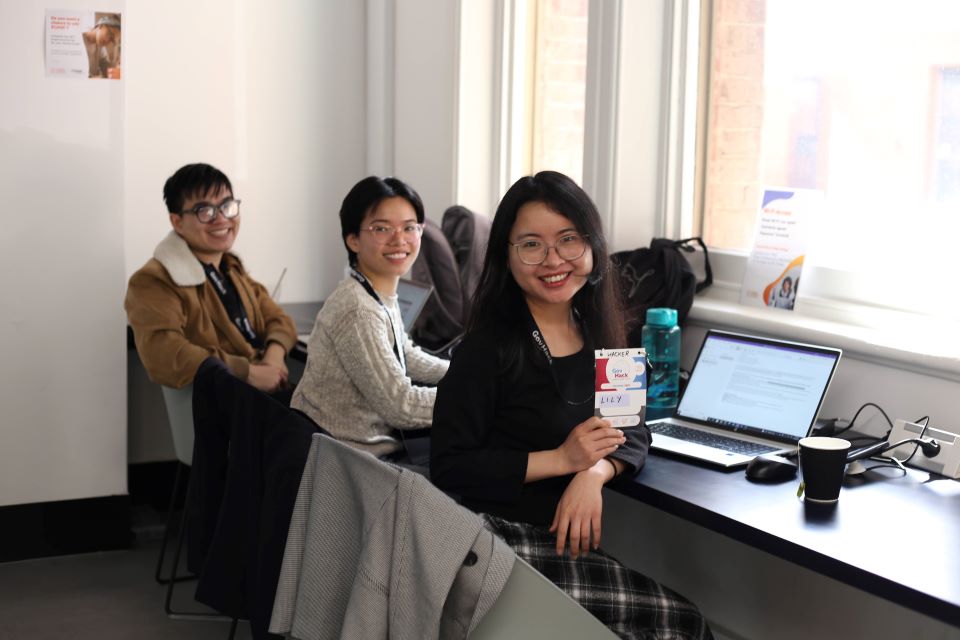 Three people smiling at camera