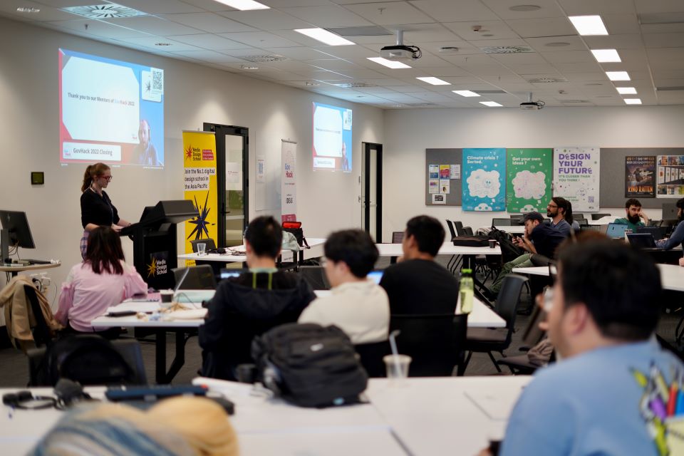 Room of participants looking at presenter