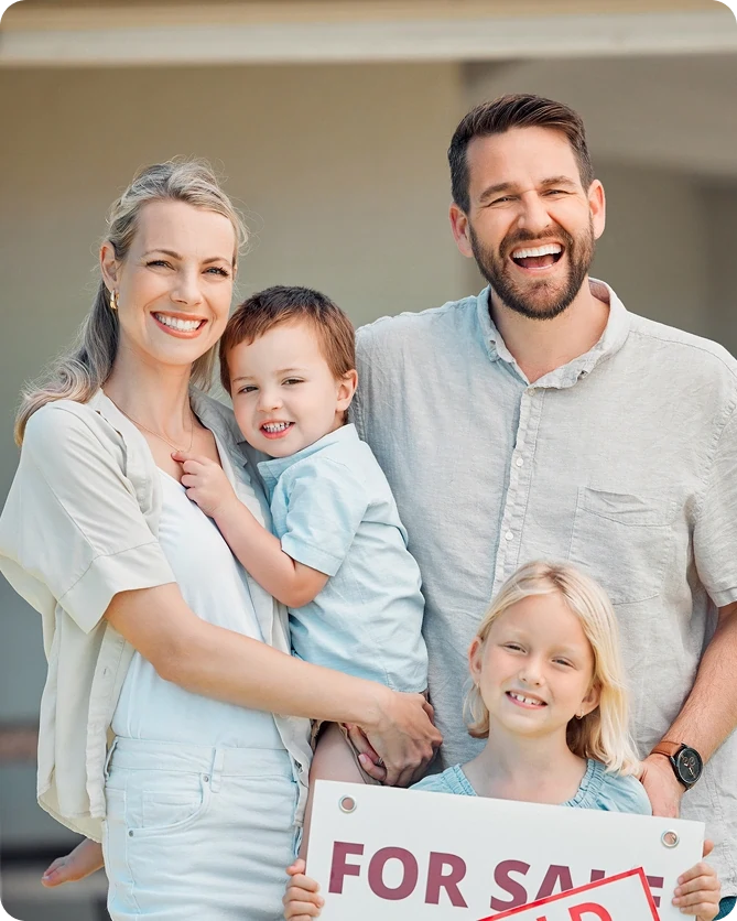 Family holding sold sign after successful home relocation with Kent Removals & Storage