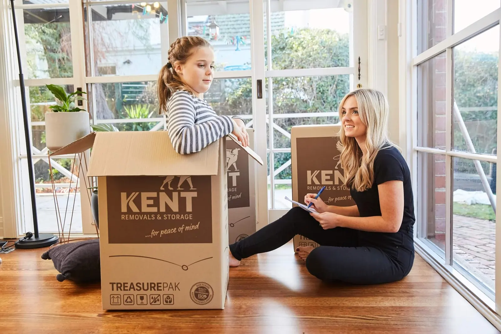 Family packing belongings into Kent Removals & Storage boxes during home relocation and moving process
