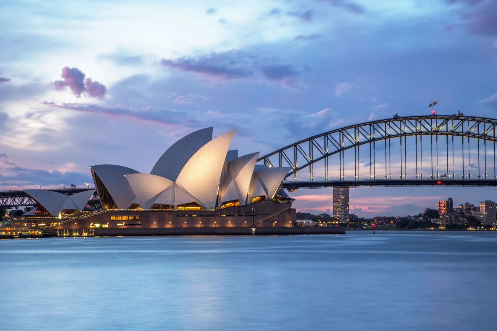 Sydney Opera House and Harbour Bridge at sunset waterfront view