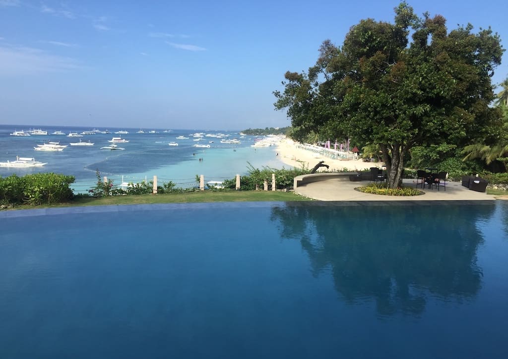 The luxury suites offer a view of the white sand beach and blue waters from a private infinity pool