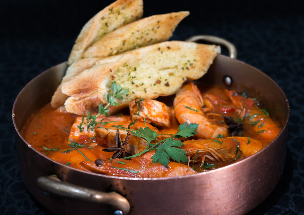 Bouillabaisse typically has two or three kinds of fish, and various shellfish (clams, mussels, shrimp, crabs, langoustines). This classic Provençal seafood stew is was with clams, lobster and fish in a broth delicately flavored with fennel and pastis, a licorice-flavored aperitif.