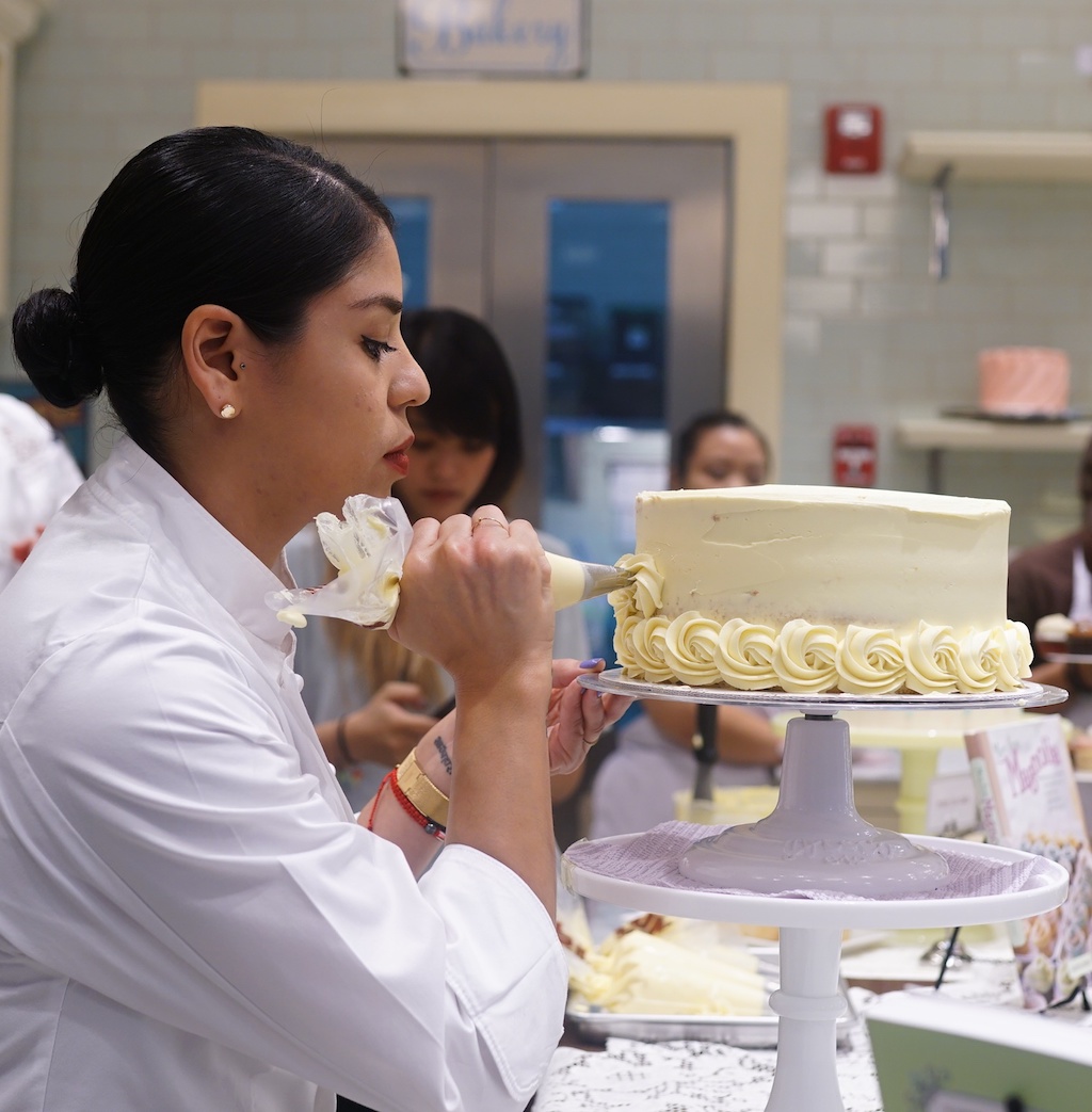 Joely Anderson, Magnolia Bakery Chicago Production Manager, carefully ices a Two-toned Rosette Cake