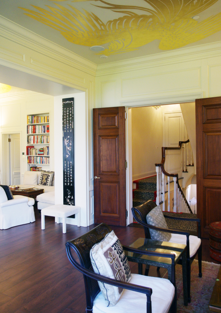 A hand-painted ceiling by Heather Jeltes decorates a smaller entertainment area on the second floor
