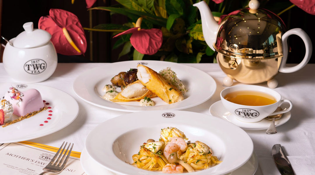 elegant plated seafood dishes with gold teapot